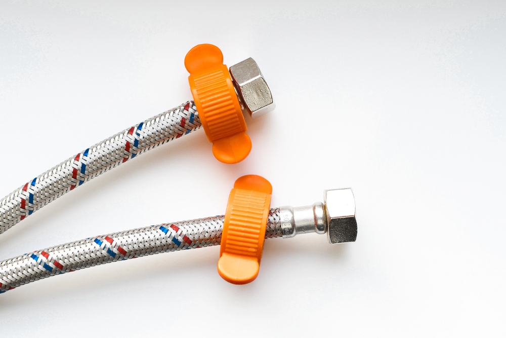 Close-up of braided water supply hoses used by Master Plumbers for professional plumbing repairs and installations in Yoakum County, TX.